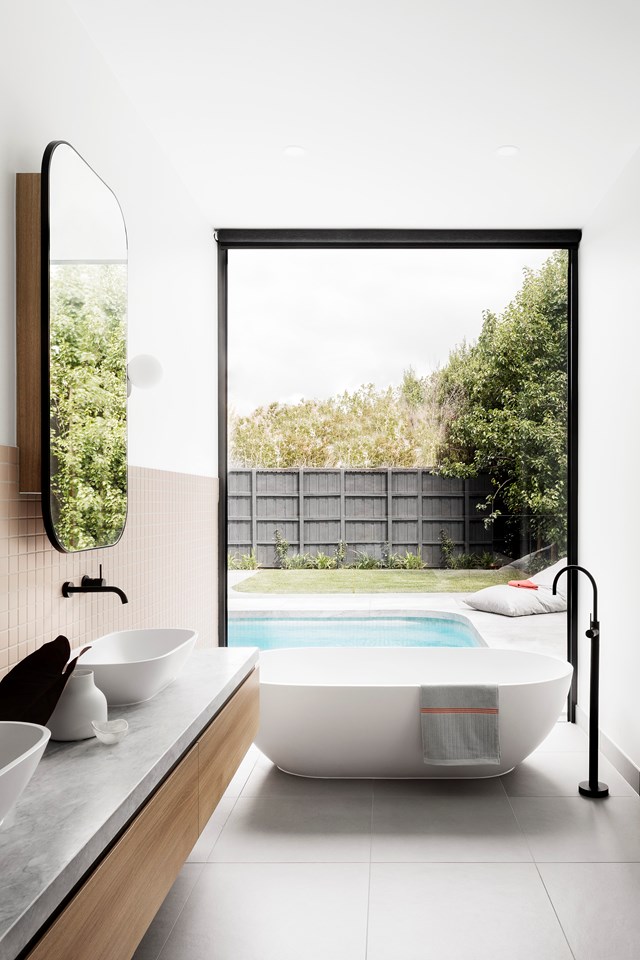 A freestanding bathtub makes a striking focal point in this spa-like bathroom which is further accentuated by matte black tapware and the black window frame. To replicate this contemporary urban oasis, use a neutral colour palette of whites, greys and black, then add texture through furniture, tiles and accessories.