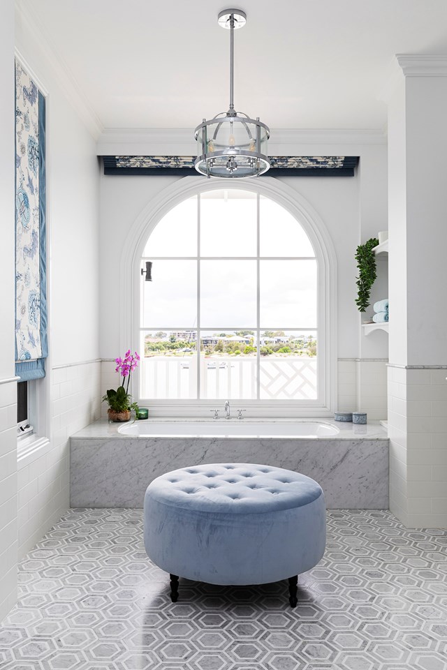 Set beneath a dramatic, oversized arched window, a marble-clad inset tub quietly anchors this [Hamptons-style bathroom](https://www.homestolove.com.au/waterfront-home-gold-coast-21855|target="_blank") in luxury. The marble surround and niched shelving offer endless scope for styling. *Photo: Eloise Van Riet-Gray / Styling: Lana Caves / Story: Home Beautiful*