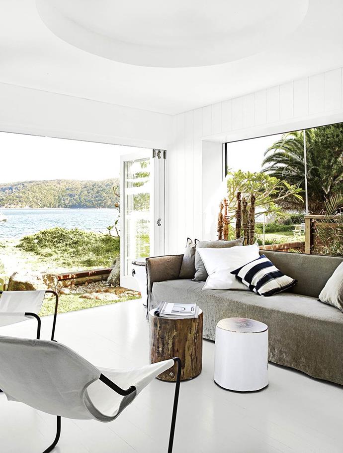 The living area of [this waterside family home](https://www.homestolove.com.au/gallery-a-waterside-family-home-on-sydneys-northern-beaches-1448|target="_blank") soaks up the views through banks of glass doors and windows. The handiwork of interior stylist Pamela Makin – "casual, not structured, laid-back and minimal" – is achieved by layering African tribal elements and inspired re-purposed finds, such as driftwood, shells and bones.