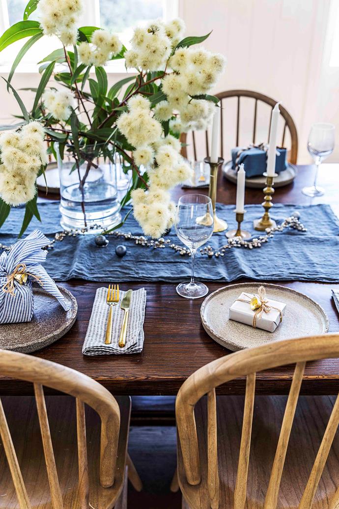 In the dining room, linen from Hale Mercantile Co. and a 'Jingle Bell' garland' from West Elm dress the table (custom-made by Andrew Farquhar).