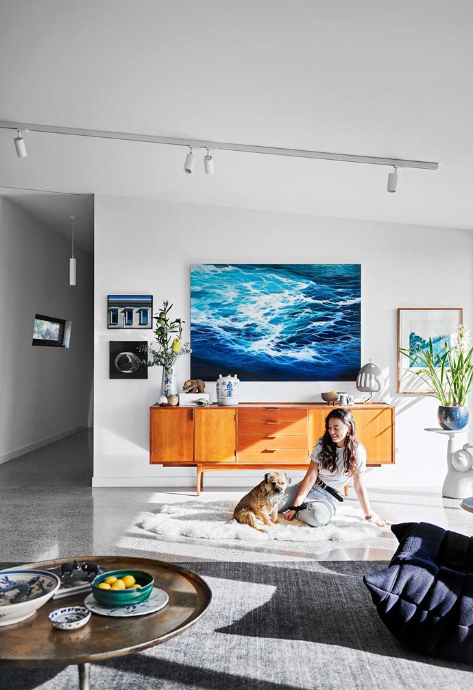 **Living area** A painting of the ocean by Nat hangs above a vintage Fred Lowen sideboard behind Harriet and Sunny.