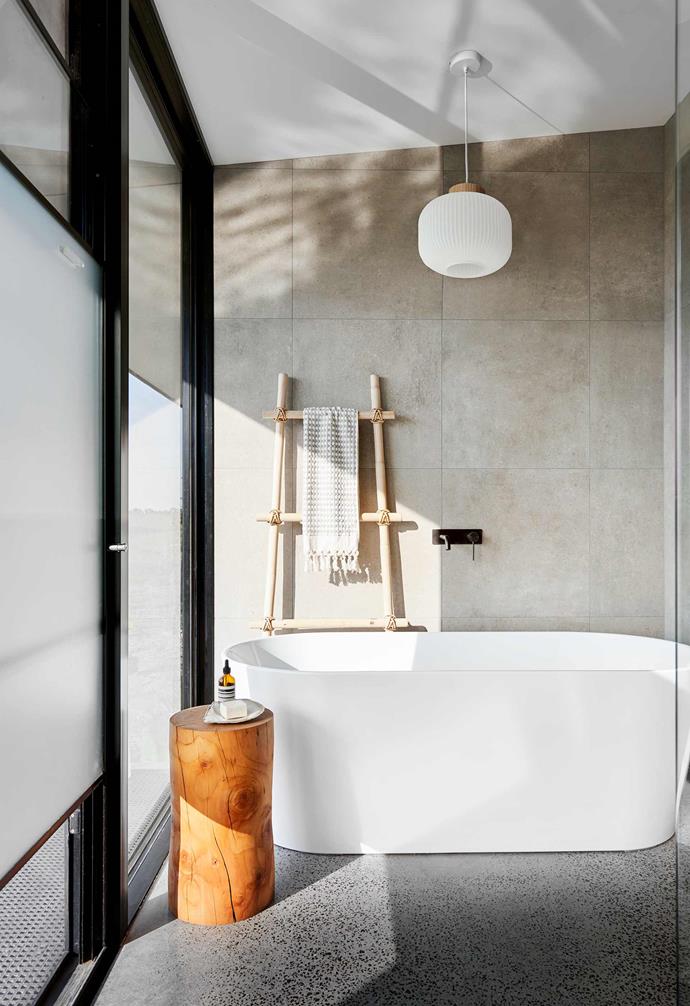 **A-family bathroom** All the bathroom floors are polished concrete. Here, the ladder is from Ikea and the light is an affordable [Beacon Lighting](https://www.beaconlighting.com.au/|target="_blank"|rel="nofollow") design. A log crafted by Shane's father keeps bath supplies handy. Pom Pom hand towel, [Miss April](https://www.missapril.com.au/|target="_blank"|rel="nofollow").