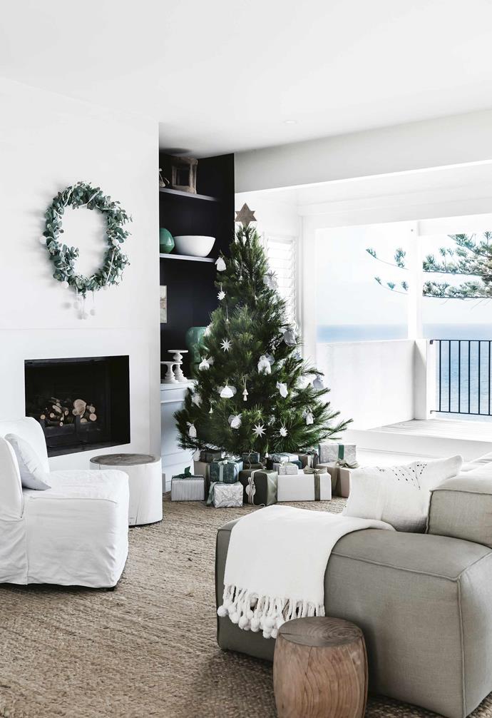In keeping with the coastal cool style of this [Mediterranean-style home](https://www.homestolove.com.au/mediterranean-style-all-white-home-16945|target="_blank"), a festive palette of wrapping paper was adopted for under the tree.