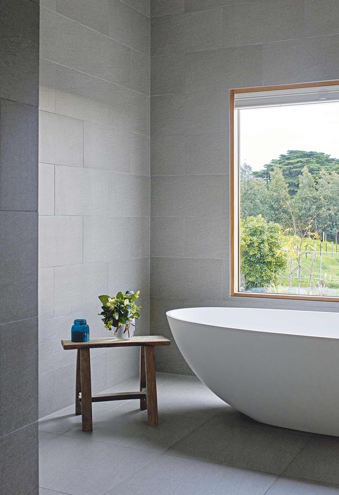 **Ensuite** Pamper time is bliss in a 'Lucia' freestanding stone bath from ACS Bathrooms, positioned to take in the picturesque view.  The 'Basaltina' matt wall and floor tiles in Pietra are from Walkers in Geelong.
