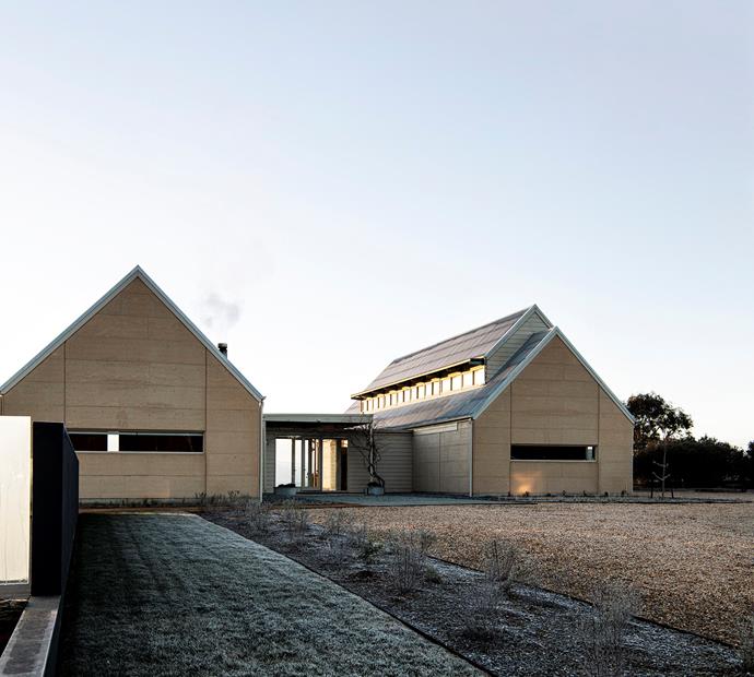 By connecting and converting two barns on their property, Nguuruu Farm, the Prior family created a [spacious four-bedroom home](https://www.homestolove.com.au/rammed-earth-farmhouse-22022|target="_blank"). "It's essentially two pavilions connected by a glass air bridge," says owner, Murray Prior. "We live in one and go to bed in the other." The barn-style home boasts six-metre ceilings, rammed-earth walls, and a solar-passive design.