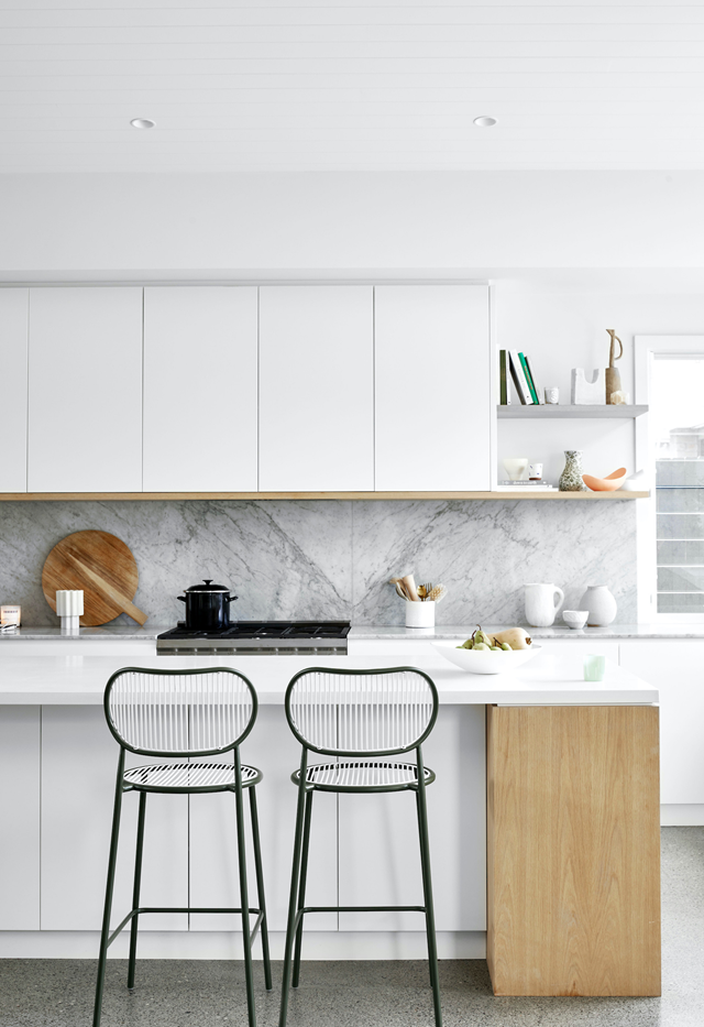 You can't go wrong with an [all-white kitchen](https://www.homestolove.com.au/all-white-kitchen-design-6370|target="_blank"). Slim, awkward spaces are made functional with shutter-front kitchen cupboards. The woodgrain is repeated on the cabinet trims to cut through the white surfaces. 

*Photographer: Dave Wheeler*
