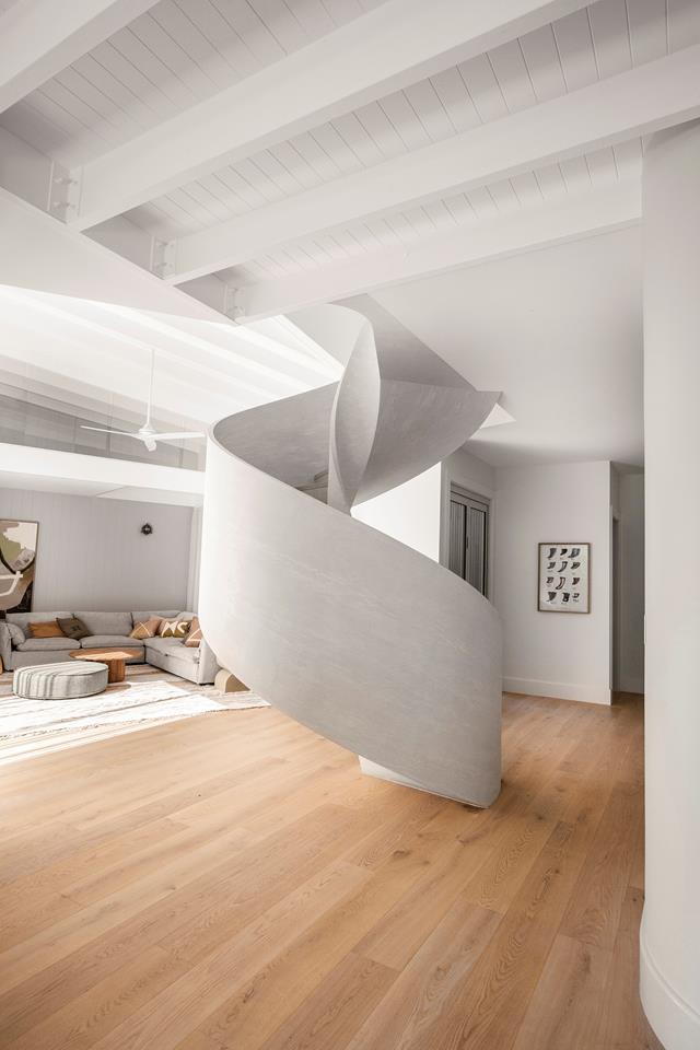 While the earthy, sandy colour palette with touches of sage green and blue is a lesson in visual serenity, it's the [curvaceous staircase](https://www.homestolove.com.au/curved-staircase-designs-20483|target="_blank") coated in a touchable limewash that truly steals the show in [Kyal and Kara's Mediterranean-inspired home](https://www.homestolove.com.au/kyal-and-kara-new-home-21483|target="_blank"). 