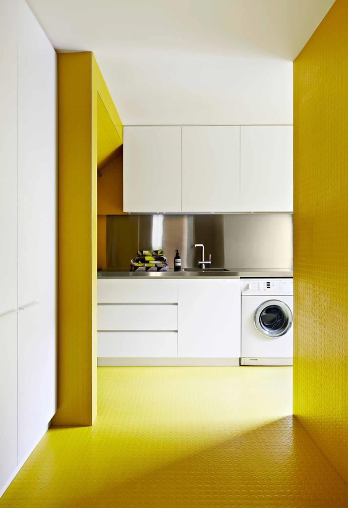 This revamped Gothic Revival home features a playful laundry zone that includes bright yellow rubber tiles which were a perfect choice for a wetzone.