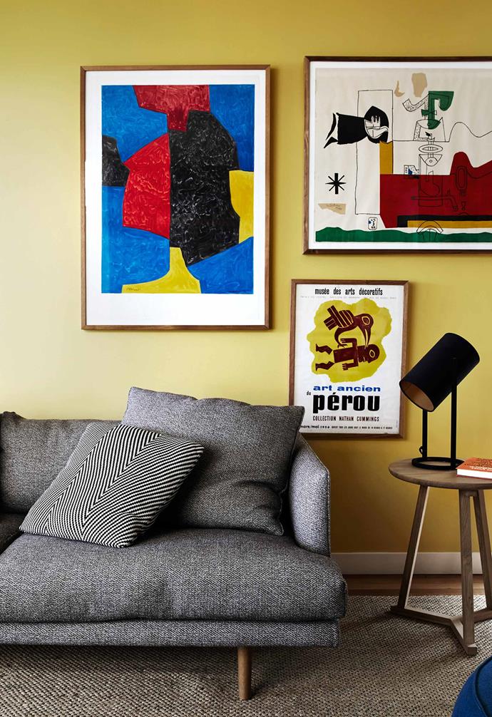 When this couple transformed their [mid-century style 1960s home](https://www.homestolove.com.au/a-cheerful-and-kid-friendly-home-renovation-3774/|target="_blank"), they adopted a bright palette designed to honour its past while adding a contemporary, kid-friendly twist. In the living room, a yellow feature wall forms the perfect backdrop for their colourful collection of art.