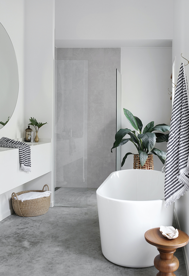 Countless Pinterest images helped inspire [this sleek ensuite](https://www.homestolove.com.au/renovated-beach-house-sunshine-coast-22148|target="_blank") in soothing grey and white. "I wanted a seamless look and feel, which the concrete floor achieves by flowing through to the shower area," says homeowner Kim, who used 'Bora Ice White' polished 600mm x 600mm tiles from Cheap Tiles Online to create the illusion of concrete continuing up the walls.