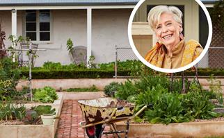 Wheelbarrow on a footpath surrounded by a kitchen garden with a portrait of Maggie Beer inset