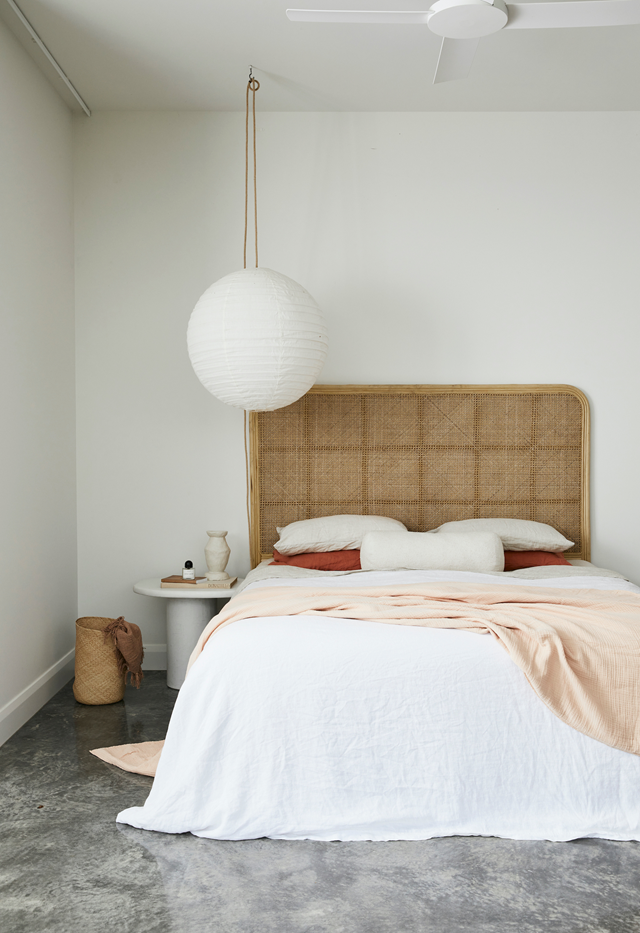 "[It's] my sanctuary," owner Sally tells of her [Byron hinterland bedroom](https://www.homestolove.com.au/new-build-byron-bay-hinterland-22186|target="_blank"). "I love lying in bed taking in the view. It's the perfect spot to watch a storm roll in; I find it hard to draw the curtains." The polished concrete floors are offset by neutral tones and minimal styling.