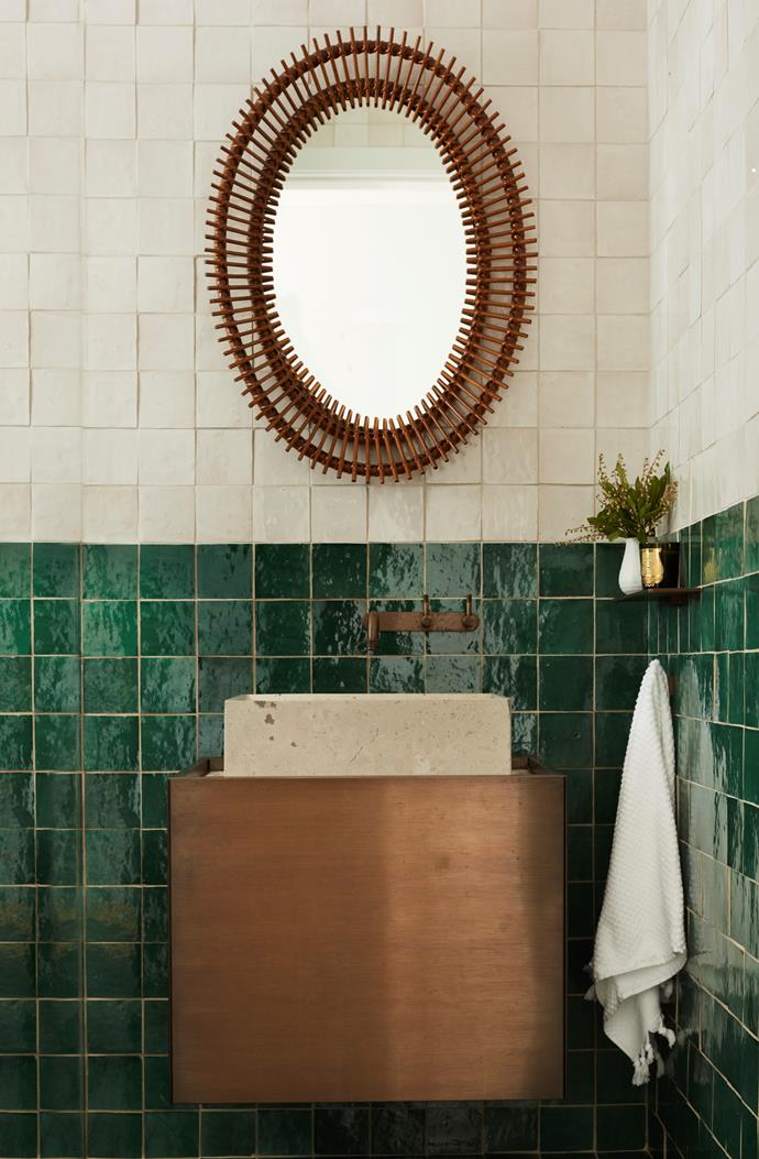 The powder room has a vintage mirror from Angelucci 20th Century and a vanity designed by Hugh-Jones Mackintosh. Wall tiles are Aït Manos from Onsite.