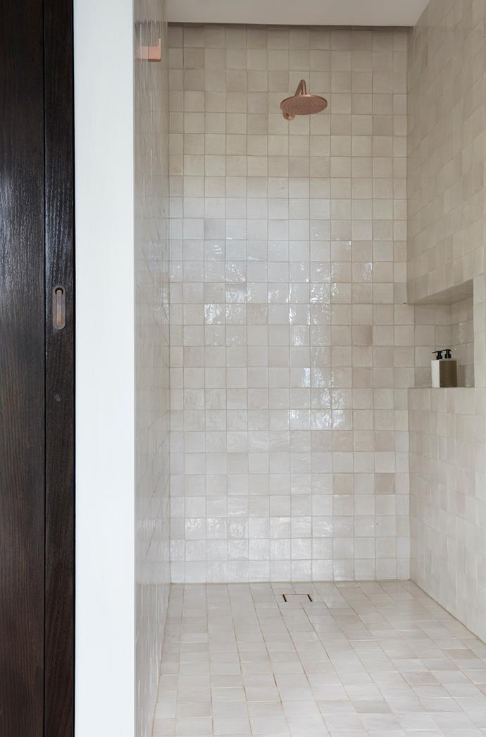 Brass fittings add a shine to the shower.  Aït Manos tiles from Onsite.