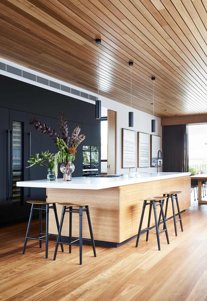 Timber is the hero of this kitchen, where the eye is drawn up between the floor and ceiling via this spectacular blackbutt timber-veneer island. Elsewhere, as with the rest of this [contemporary family home in Torquay](https://www.homestolove.com.au/contemporary-family-house-torquay-22236|target="_blank"), the palette is kept simple and momochromatic. 