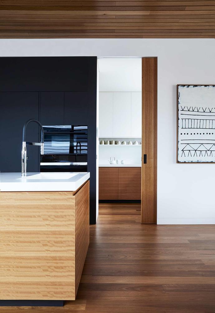 **Make it flexible** The high end kitchen of this contemporary family home in Torquay was built for entertaining. Above the inset sink, a sink mixer from Reece makes cleaning a breeze.