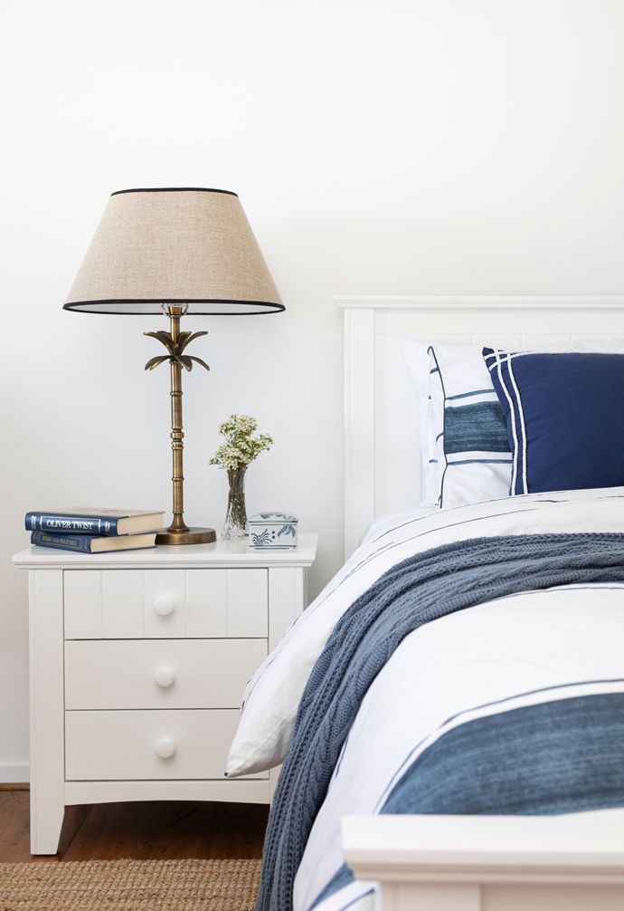 This is the bedroom our grandchildren use, and it has two king single beds," says Jo of the nautical-style room, on the middle level of the home. Classic bedlinen by Pillow Talk and a 'Noah' bedside table and lamp from One World Noosa are relaxed and comfortable.