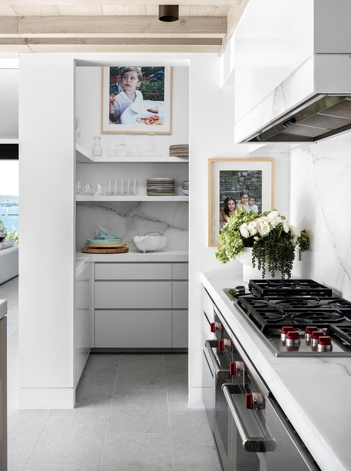 This home's striking coastal location (a hint of which can just be seen here) has informed much of its interior style; a calming palette of blonde timbers, marble whites and soft greys. With a double oven and stovetop in the foreground and the perfectly placed butler's pantry behind, this [once-humble Sydney bungalow](https://www.homestolove.com.au/california-bungalow-transformed-into-a-contemporary-coastal-home-22298|target="_blank") is well set for entertaining.
