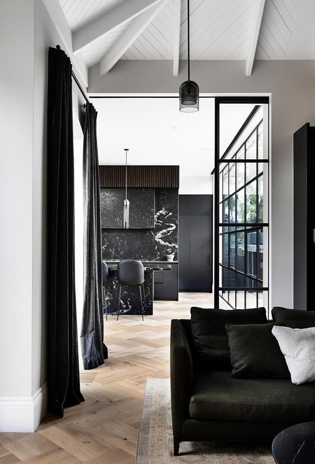 Influences from bygone eras and forgotten trades form lasting connections in this [early 1900s home](https://www.homestolove.com.au/early-1900s-house-revamped-monochrome-palette-21872|target="_blank"), deftly unified via a sophisticated monochrome palette. Dark-grey drapes and furniture in the informal living area provide a strong accent against the pale oak floors.