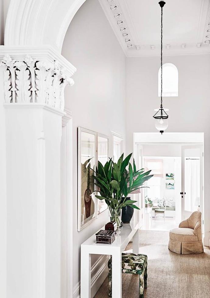 Barely touched since the 1800s, a [handsome Victorian house](https://www.homestolove.com.au/adelaide-braggs-restored-victorian-home-19113|target="_blank") in a leafy Melbourne suburb has a newfound sense of lightness thanks to a robust renovation by Adelaide Bragg. In the hallway, the home's original tessellated flooring lays protected beneath a neutral rug. The stool has been upholstered in fabric from Tigger Hall Design.