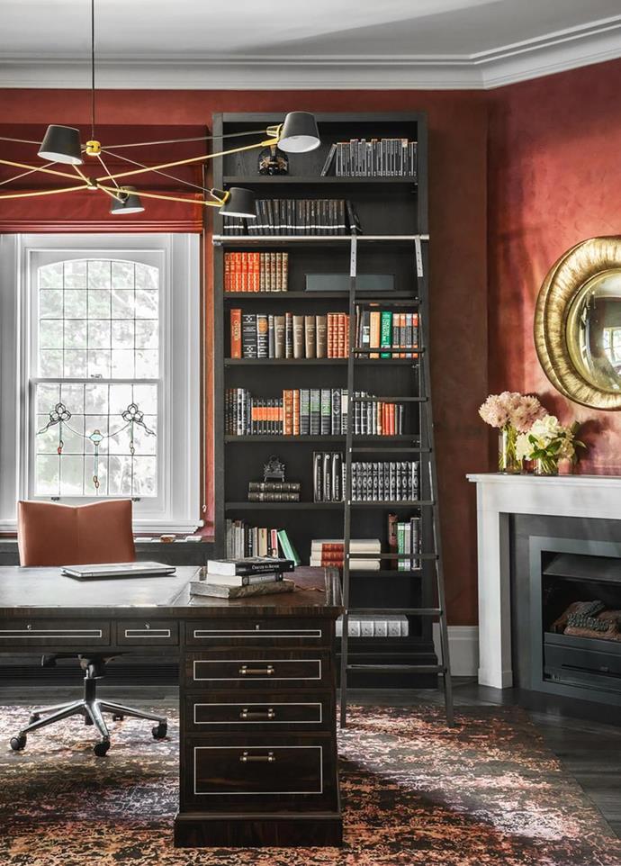 In the richly decorated study of [this eclectic Melbourne home](https://www.homestolove.com.au/eclectic-melbourne-home-19866|target="_blank") with international appeal, a 'Pivot' chandelier from Brendan Ravenhill hangs over the desk, while a black bookcase and sliding ladder brings extra glamour.