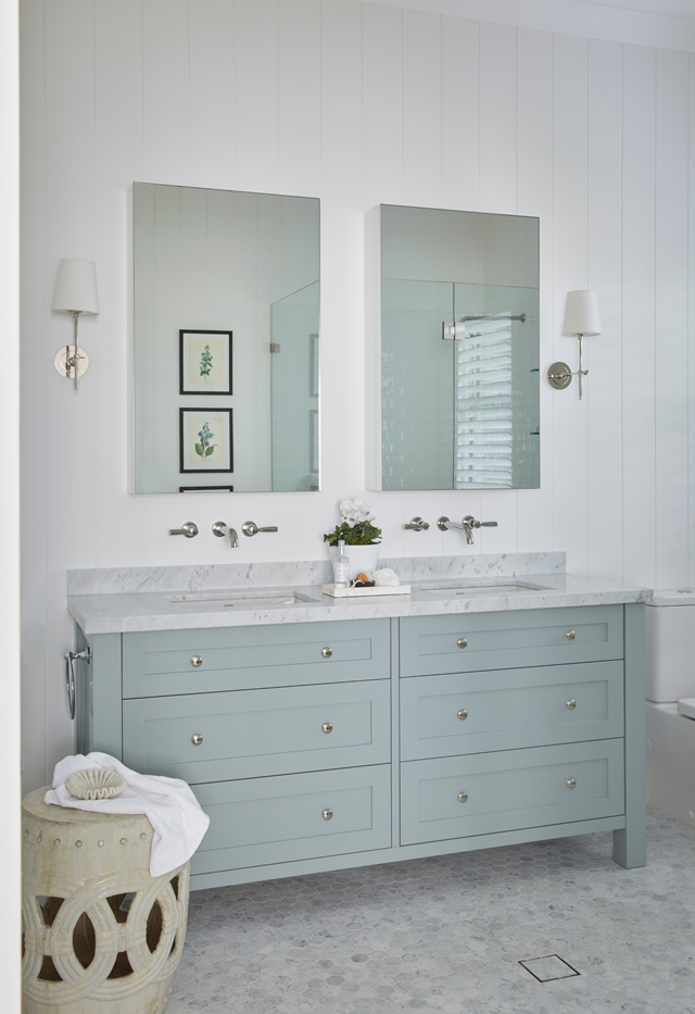 **Classic with modern touches**<br>
[This striking bathroom](https://www.homestolove.com.au/weatherboard-hamptons-home-southern-highlands-22373|target="_blank") combines VJ panelling and classic chrome tapware with clever use of marble. On the floor are tiny marble hex mosaics, while large format features in the vanity atop soft blue-grey cabinetry. "The colours are very peaceful but also gender neutral, which is ideal for an ensuite," says owner Georgia.