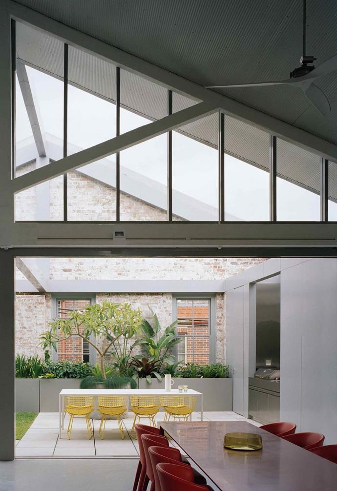 A family in Redfern enlisted the help of Ian Moore Architects to revamp this [former warehouse](https://www.homestolove.com.au/warehouse-conversion-redfern-20831|target="_blank") into a contemporary home that embraces its industrial heritage. With a focus on retaining the original brick walls and exposed timber roof trusses, the design for this home centered on amplifying natural light and indoor-outdoor flow.