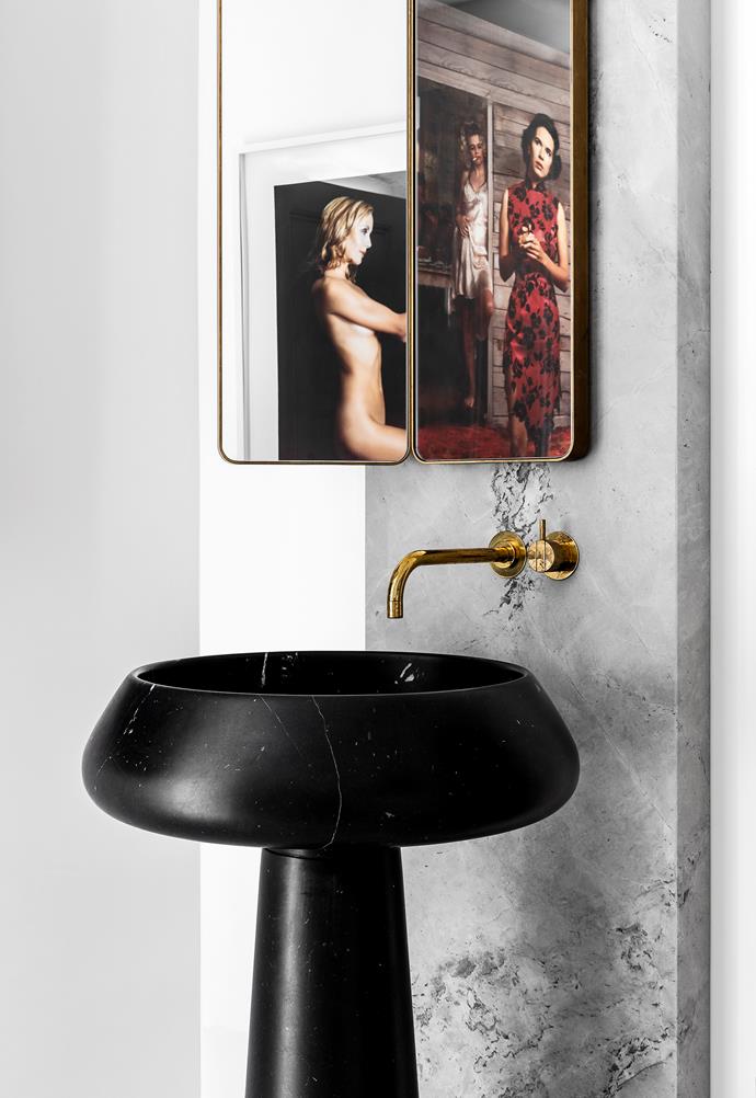Artworks reflected in the powder room mirrors are (from left) Red Body by Patricia Piccinini and Something More #1 by Tracey Moffat. 'Bjhon' basin by Angelo Mangiarotti from Artedomus. Vola tapware from Mary Noall.