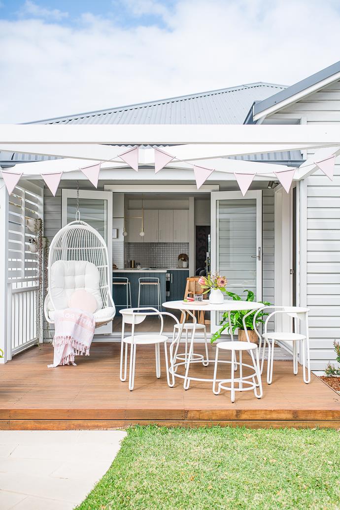 The exterior is equally enticing, decked out with a Fenton & Fenton 'The Palm' rattan hanging chair, handmade marine ply bunting painted in Dulux Soft Satin, and a generous stretch of lawn.