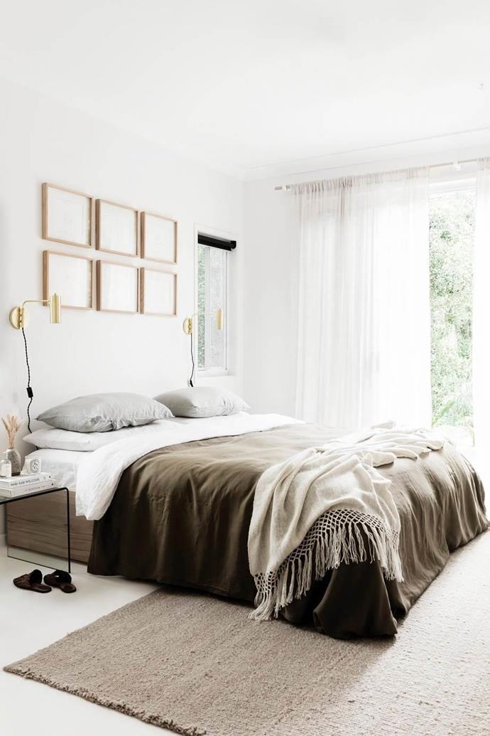 Gold wall lights illuminate the calming neutrals and warming textures of this creative couple's bedroom in their [Byron Bay home](https://www.homestolove.com.au/a-byron-bay-home-filled-with-handcrafted-finds-19045|target="_blank"). 