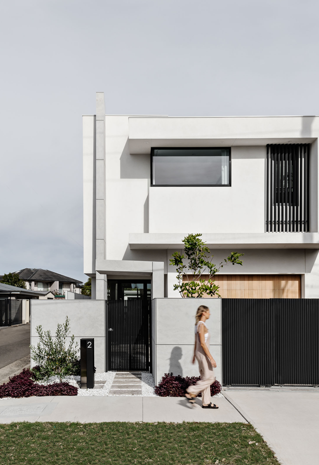 With a black front access gate and a slimline letterbox paired with white rockery, a monochrome colour scheme gives this [Mediterranean-inspired abode](https://www.homestolove.com.au/contemporary-minimalist-australian-family-home-22441|target="_blank") a minimalist and modern feel.