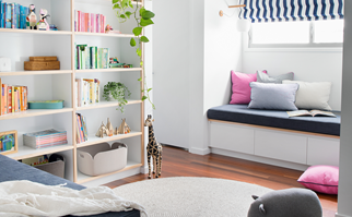 Contemporary kids play room with built-in seating and colour-coordinated bookshelf