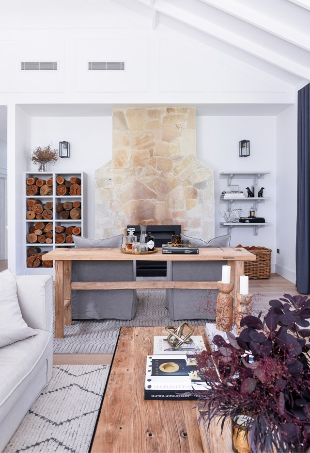 A central stone fireplace in [this renovated Blue Mountains cottage](https://www.homestolove.com.au/stylish-white-weatherboard-cottage-leura-22479|target="_blank") makes a statement in an otherwise white space, the stone picking up details and texture in timber floor and furnishings.