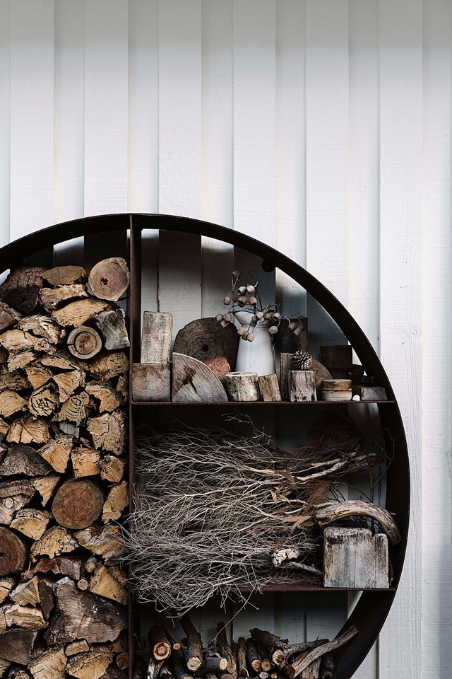 A circular wood stacker by [Unearthed Garden](https://www.unearthedgarden.com.au/product/wood-stacker/|target="_blank"|rel="nofollow") at a renovated [mid-century modern beach house](https://www.homestolove.com.au/renovated-mid-century-modern-beach-shack-flinders-22501|target="_blank").