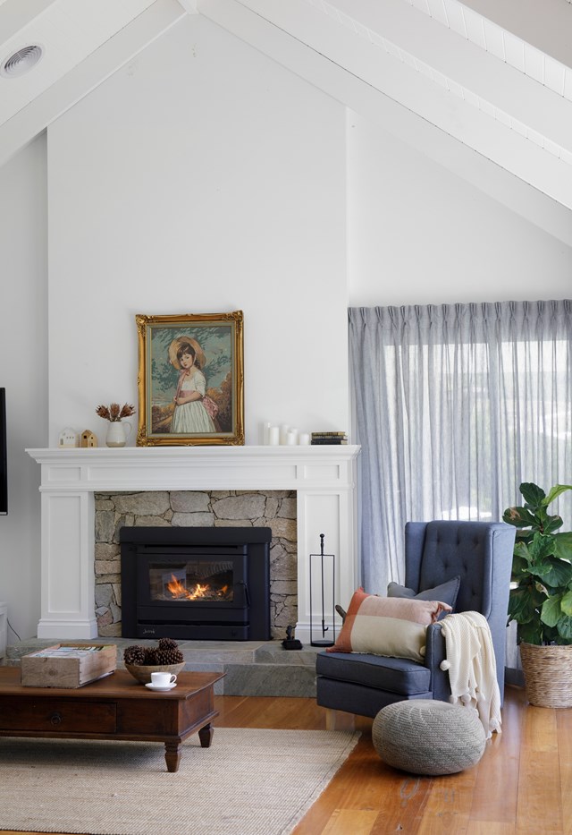 The cosy stone fireplace in [this contemporary farmhouse](https://www.homestolove.com.au/modern-farmhouse-build-hinterland-22527|target="_blank"|rel="nofollow") keeps the focus intimate beneath soaring vaulted ceilings.