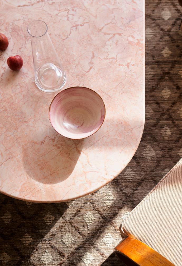 Pink stone is teamed with pink upholstery and ceramics in the laidback lounge area.