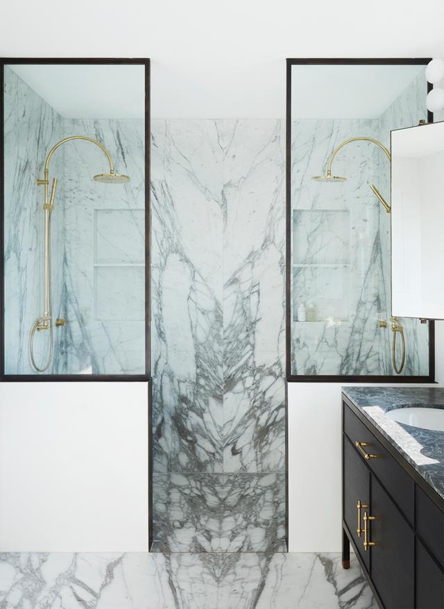Striking bookmatched Calacatta Vagli marble features on the shower walls and floor of this [timeless bathroom](https://www.homestolove.com.au/multi-storey-harbourside-family-home-sydneys-east-22087|target="_blank") conceived by interior architect Debbie Pollak of Pollak Design.
