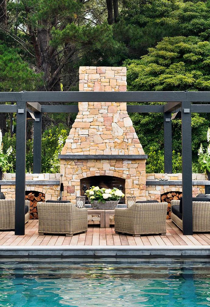 Chyka Keebaugh's [Mornington Peninsula weekender](https://www.homestolove.com.au/mornington-peninsula-weekender-19583|target="_blank") is as luxe as you'd expect, with one of the key highlights being this relaxed outdoor entertaining space. The generous fireplace is clad in warm stone that provides a stunning visual contrast to its natural surrounds.