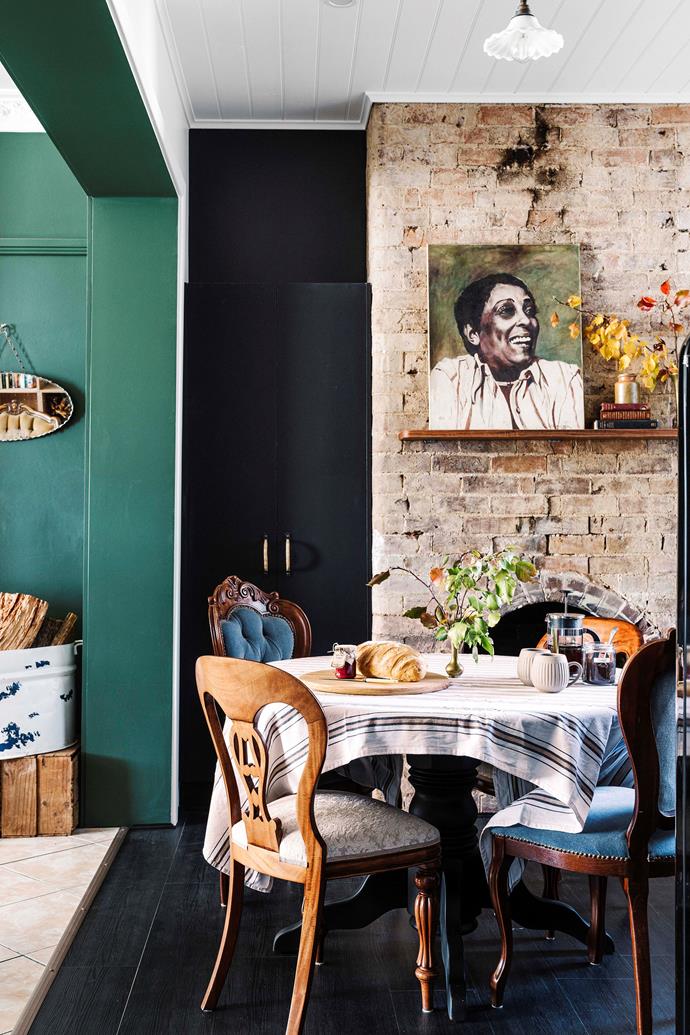 From the collection of autumnal leaves to the natural tones of exposed brick and deep green wall, there's a cumulation of elements to take your eye around the dining/living room of this [bakery turned family home](https://www.homestolove.com.au/bakery-holiday-home-conversion-22809|target="_blank") in the NSW Southern Tablelands. "When you collect things based on what you love, once you put it together, it all ties in," says owner, Elise.