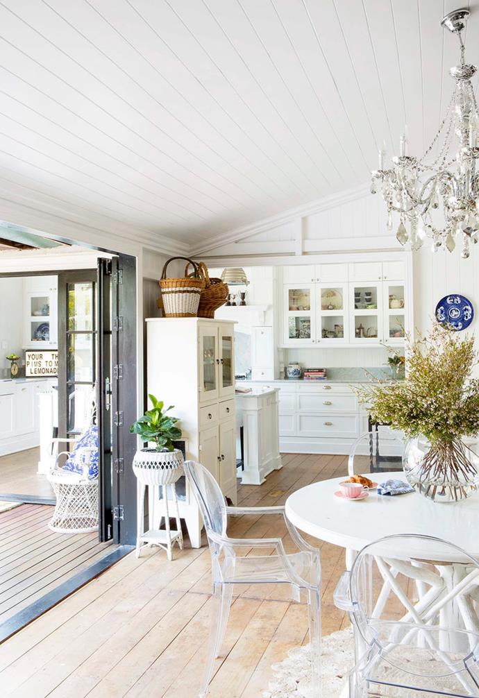 **DINING ROOM** By opening up the walkway into the kitchen and adding French doors out to the new back deck, the former casual eating area has been transformed into a light, white dining room.
