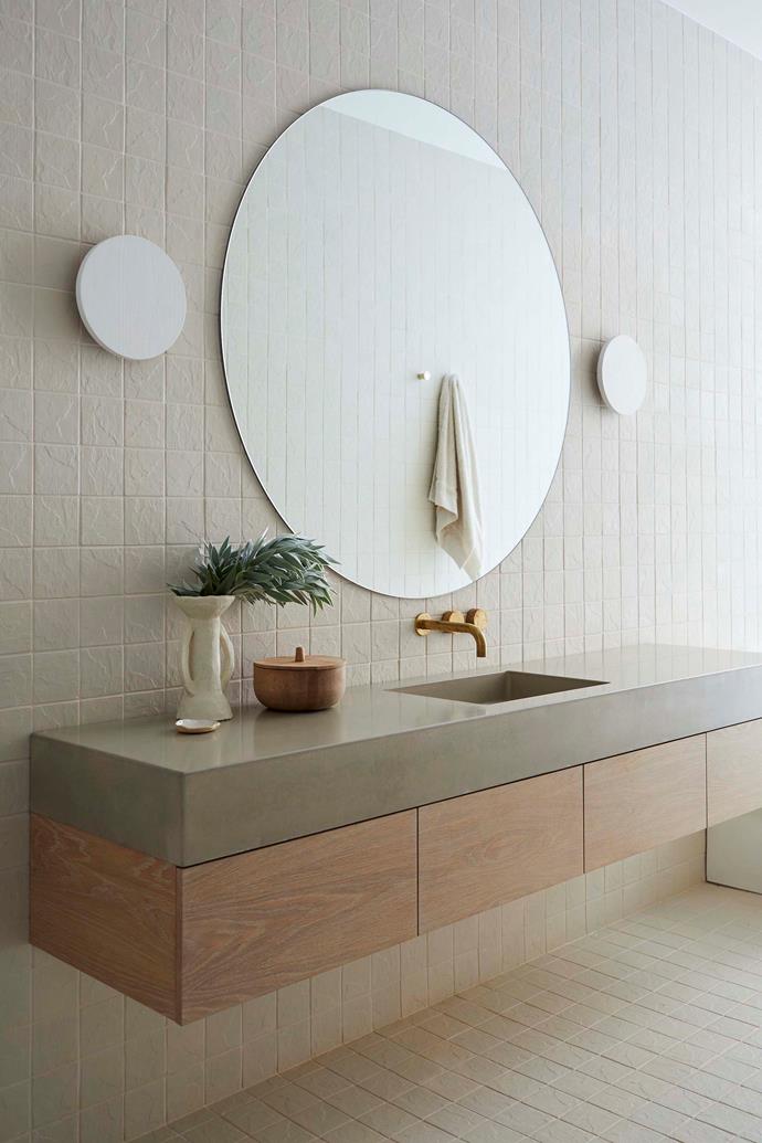 In the ensuite bathroom, a clever combination of off-white mosaic tiles, chunky concrete (on the bench) and tumbled glass tapware (Milli from Reece) make this one of Kristal's favourite spaces.