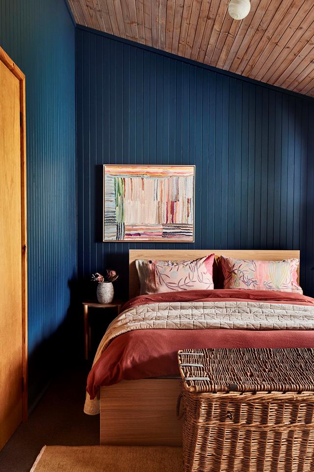 Known as The Blue Room, this space feels removed from the rest of the cabin. The artwork by Emma Cleine introduces shades of red and pink that recur on the bed linen.