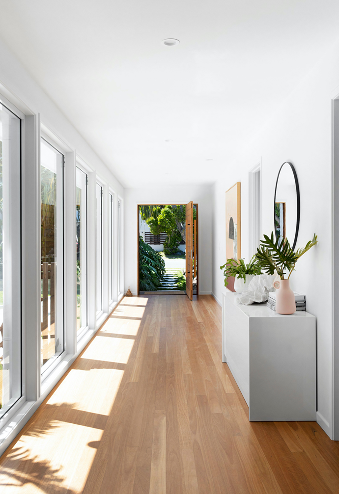 Blackbutt timber floorboards line the hallway overlooking the pool of this [light-filled abode in coastal northern NSW](https://www.homestolove.com.au/coastal-home-northern-nsw-22199|target="_blank"). 