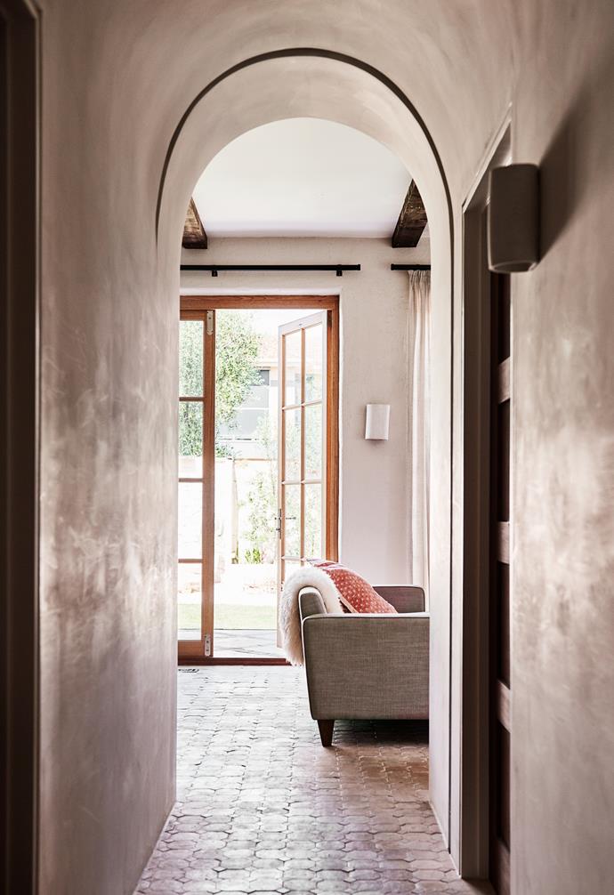 Rounding the corner of the hallway, the living and kitchen space opens up, full of [natural light](https://www.homestolove.com.au/how-to-increase-natural-light-in-home-15836|target="_blank"). "We are always in the kitchen/living/playroom area," says Georgia. "You'll find us going out to the vegie garden to pick herbs for our homemade pizza or gathering leaves to paint and do arts and crafts with at the table."