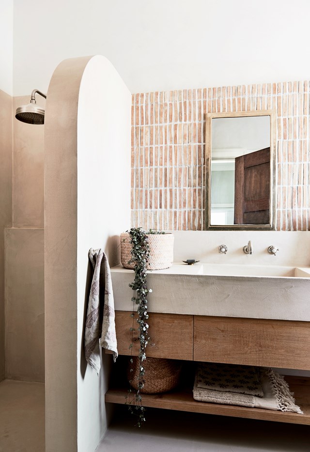 This Mediterranean-inspired spa-like haven is full of natural materials and rustic touches that make it shine. For example, an integrated showerhead is simple yet luxurious addition, creating a serene and soothing ambience.
