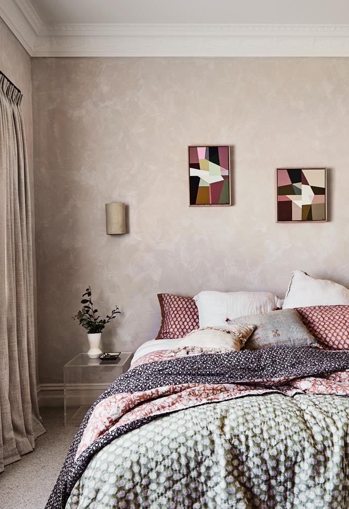 In the master bedroom, the bed is layered with sumptuous linens and cushions, with a wall light above from the At Home With Georgia Ezra range in a similar subtle hue as the walls. The carpet from Carpeteria adds to the comforting feel, while Greta Laundy artworks from Art to Art add a dose of colour.