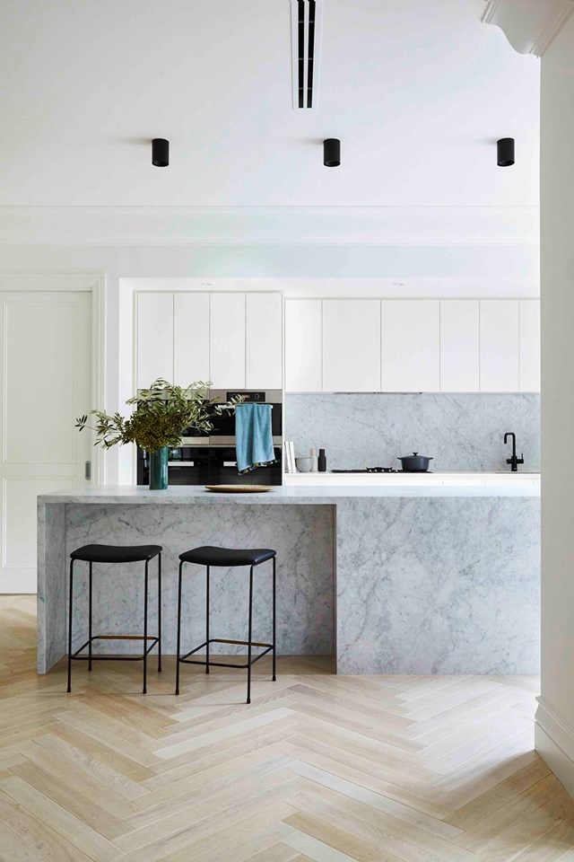 Luxe Carrara marble and secret storage behind 2-pac cabinetry make for a streamlined kitchen in [this renovated bayside home](https://www.homestolove.com.au/modern-spanish-style-home-melbourne-21563|target="_blank") in Melbourne.
