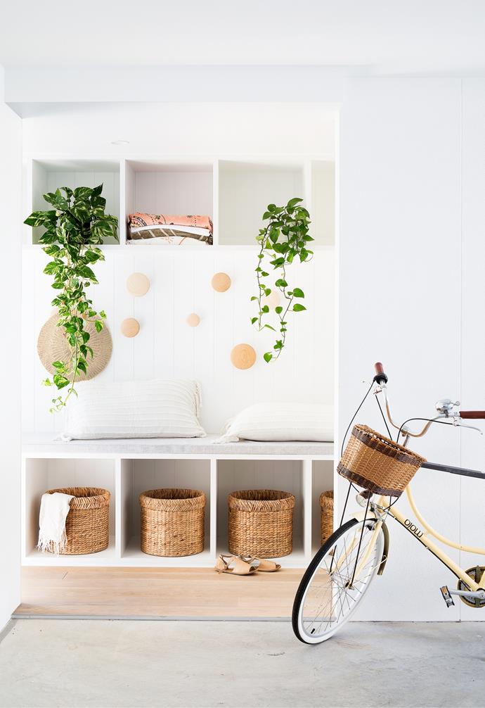 One of Danielle's must-haves was a "sand room" that acts as a zone for beach bags, towels and shoes. "I thought it would be a good way to reduce the amount of sand getting trekked through the house," she says. Muuto 'The Dots' wall hooks in Oak from Surrounding Australia keep beach bags in easy reach, while a built-in bench includes spaces for Freedom baskets, which stow throws and shoes.