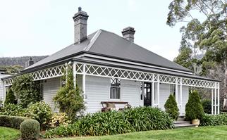 Exterior of heritage listed weatherboard farmhouse at Cloud River Farm in Tasmania