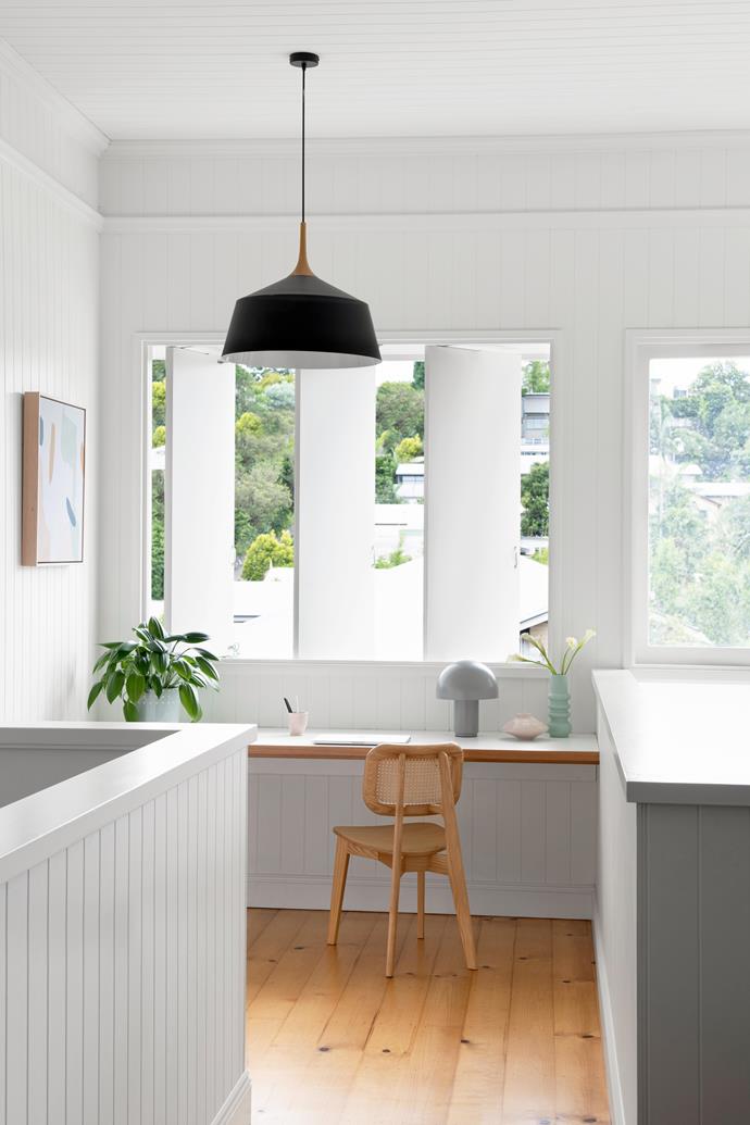 Challenging the idea that a stairway landing is a "dead zone", a cleverly placed workspace fits right into this [WWII renovated Queenslander home](https://www.homestolove.com.au/queenslander-double-height-renovation-22963|target="_blank"). Vertical pivoting panels allow for breeze and light to enter the space, while the slimline desk and simple design means this workspace remains totally unobtrusive.